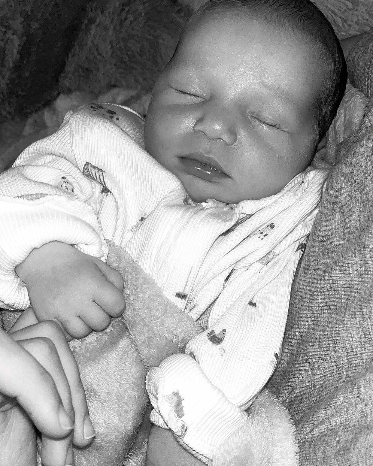Remi joined the competition — help win amazing prizes! baby, newborn, sleeping, hand, blanket, clothing, cozy, infant, portrait, closeup, soft_texture, monochrome, peaceful, cute, child, rest, warm, toddler, human, face