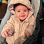 baby, child, hooded_jacket, quilted_clothing, car_seat, smiling, happy, indoor, closeup, face, young_child, warm_clothing, infant, person, cute, portrait, seated, comfort, jacket, hood