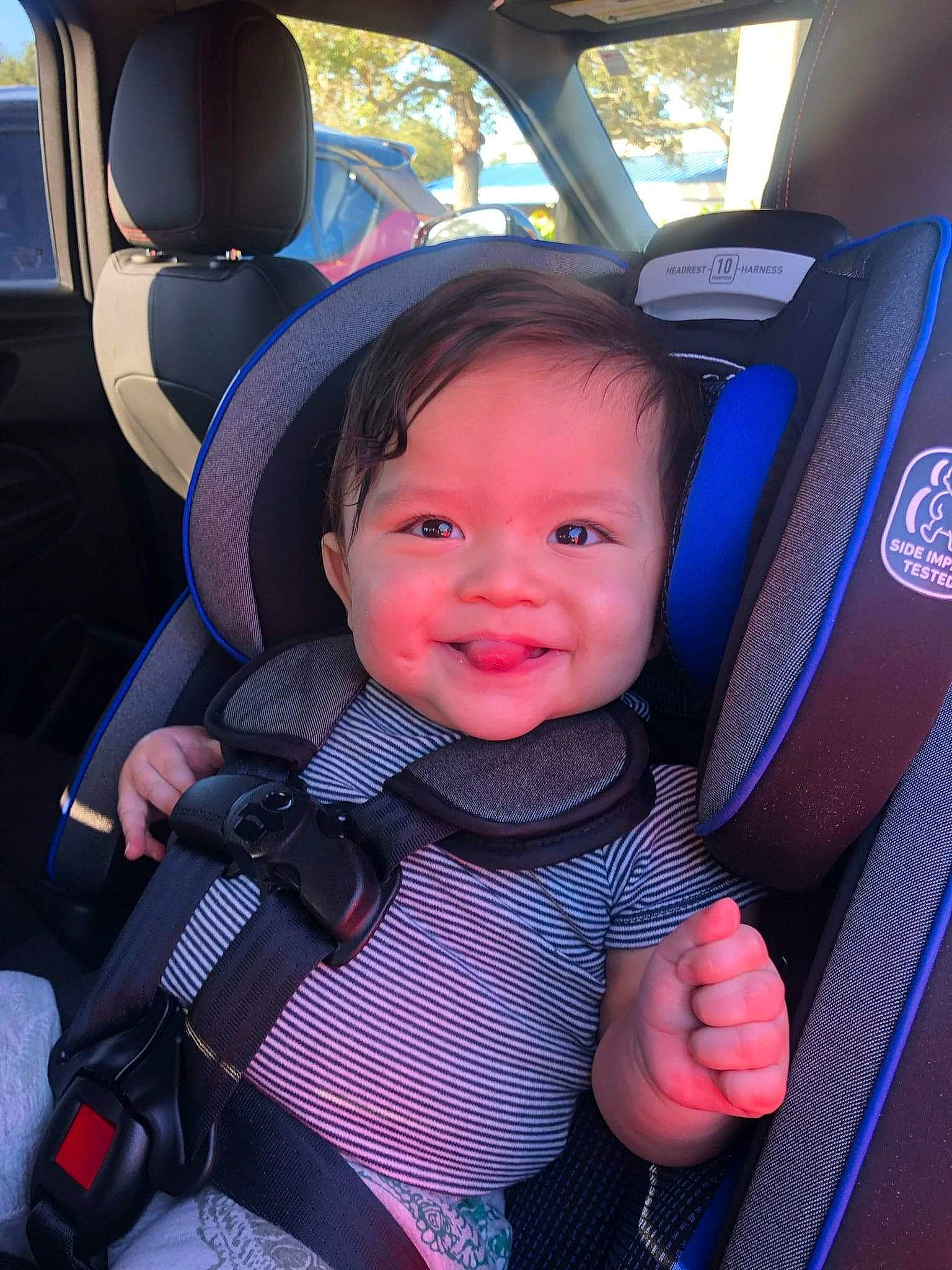 Armando is registered to the contest to win money with this photo: auto_part, automotive_design, automotive_exterior, baby, baby_in_car_seat, car, car_seat, car_seat_cover, electric_blue, eye, family_car, head_restraint, joy, motor_vehicle, person, plant, seat_belt, smile, steering_wheel, toddler