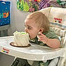 birthday, cake, celebration, child, cute, dinosaur_clothing, eating, food, fun, happy, high_chair, indoor, messy, party, person, seat, table, toddler, toy, young_child