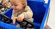 Zander joined the competition — help win amazing prizes! adult, aisle, bag_of_potatoes, blonde_hair, child, clothing, floor, grocery_store, hand, happy, person, shoes, shopping, shopping_cart, smile, steering_wheel, supermarket, tattoo, toddler, toy_car