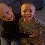 Cameron is registered to the contest to win money with this photo: child, children, smiling, hugging, indoor, carpet, pajamas, long_sleeve, sofa, furniture, happy, family, home, kid, friendship, toddler, casual_clothing, sitting, cute, portrait