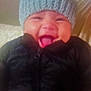 baby, child, smiling, hat, knitted_hat, black_jacket, happy, laughing, indoor, cute, face, headwear, warm_clothing, infant, person, portrait, funny, adorable, closeup, cozy