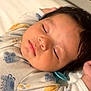 Dakota is registered to the contest to win money with this photo: baby, sleeping, infant, onesie, pacifier, closeup, face, peaceful, child, cute, soft_lighting, indoors, resting, young_child, portrait, cozy, animal_prints, skin, head, hand