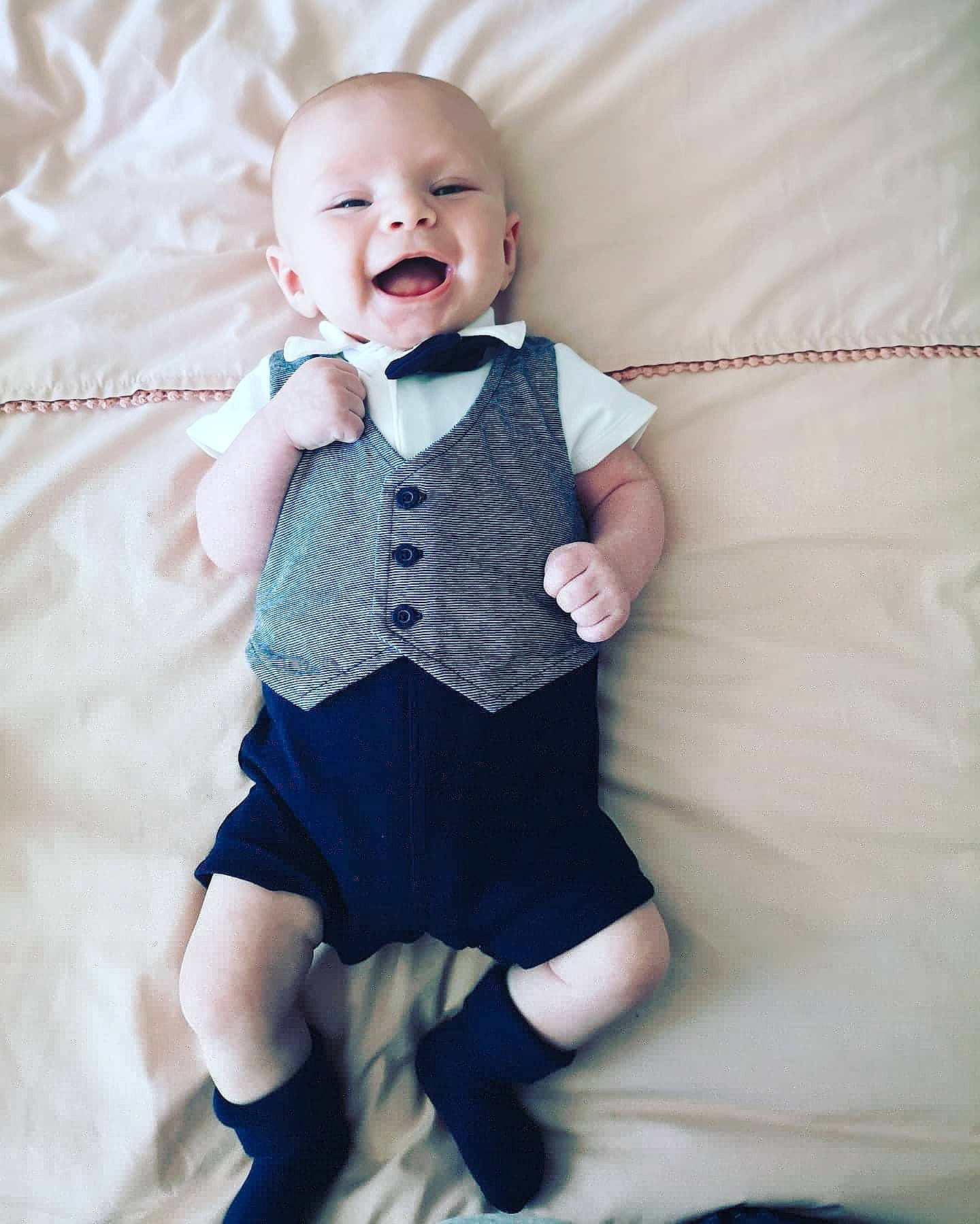 Kurtis is registered to the contest to win money with this photo: baby, baby_toddler_clothing, blue, cheek, child, dress, face, facial_expression, head, joint, leg, outerwear, person, product, skin, sleeve, smile, suspenders, tie, toddler