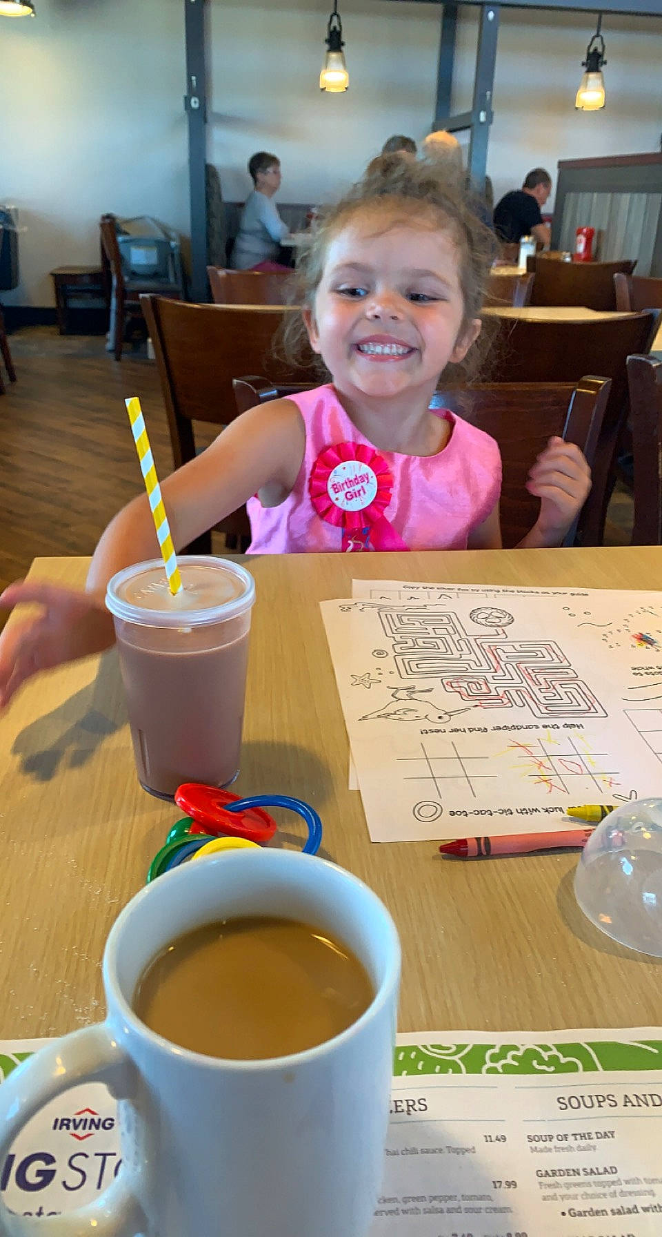 Charlotte is registered to the contest to win money with this photo: arm, chair, child, coffee, coffee_cup, cup, drink, drinking_straw, drinkware, food, fun, furniture, green, joy, leisure, person, serveware, smile, table, tableware