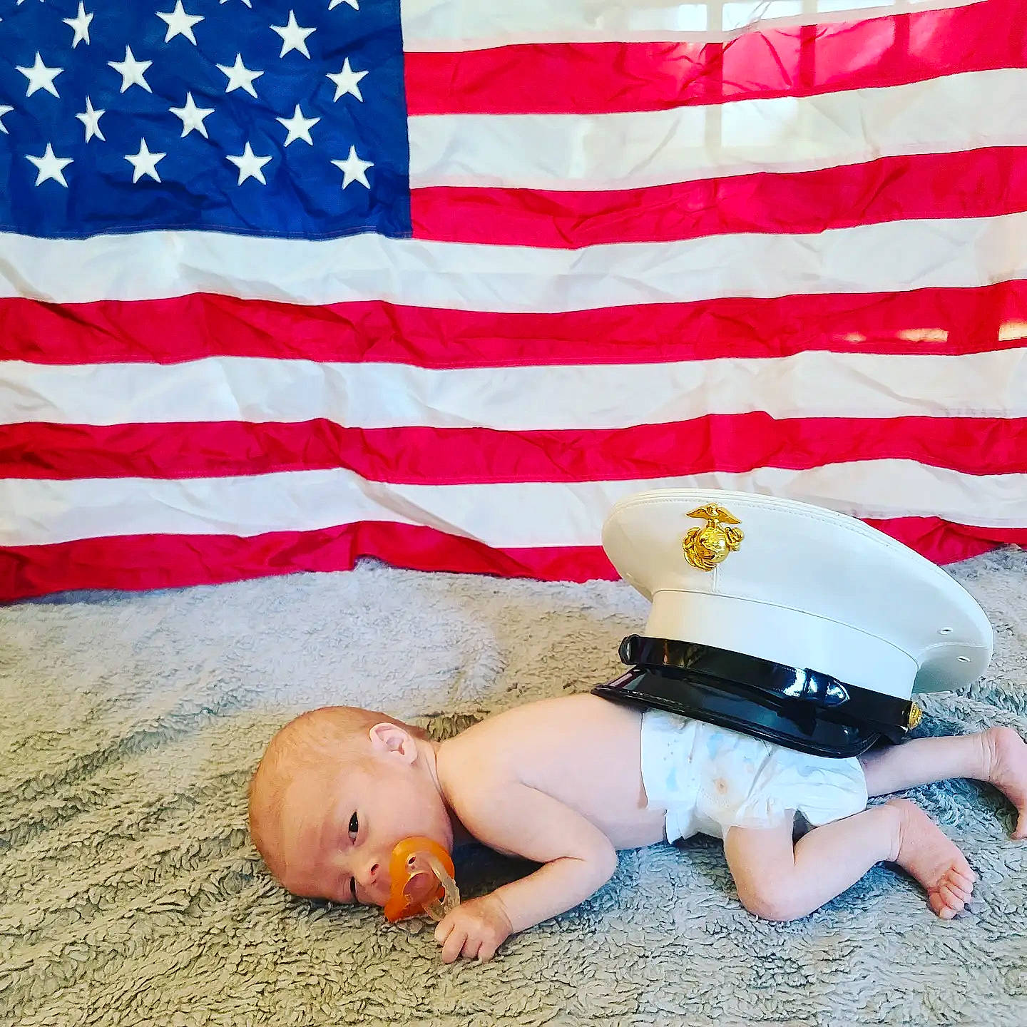 Theo joined the competition — help win amazing prizes! baby, baby_toddler_clothing, barefoot, cap, event, flag, flag_day_usa, flag_of_the_united_states, foot, hat, human_leg, knee, leg, leisure, people, person, sitting, sun_hat, thigh, toddler