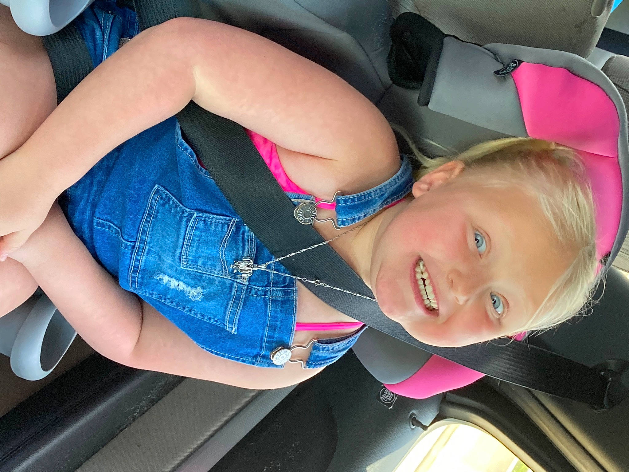 Makinzy is registered to the contest to win money with this photo: auto_part, automotive_design, car, elbow, electric_blue, facial_expression, finger, fun, hairstyle, happy, joy, knee, motor_vehicle, mouth, person, pink, skin, smile, thigh, vehicle