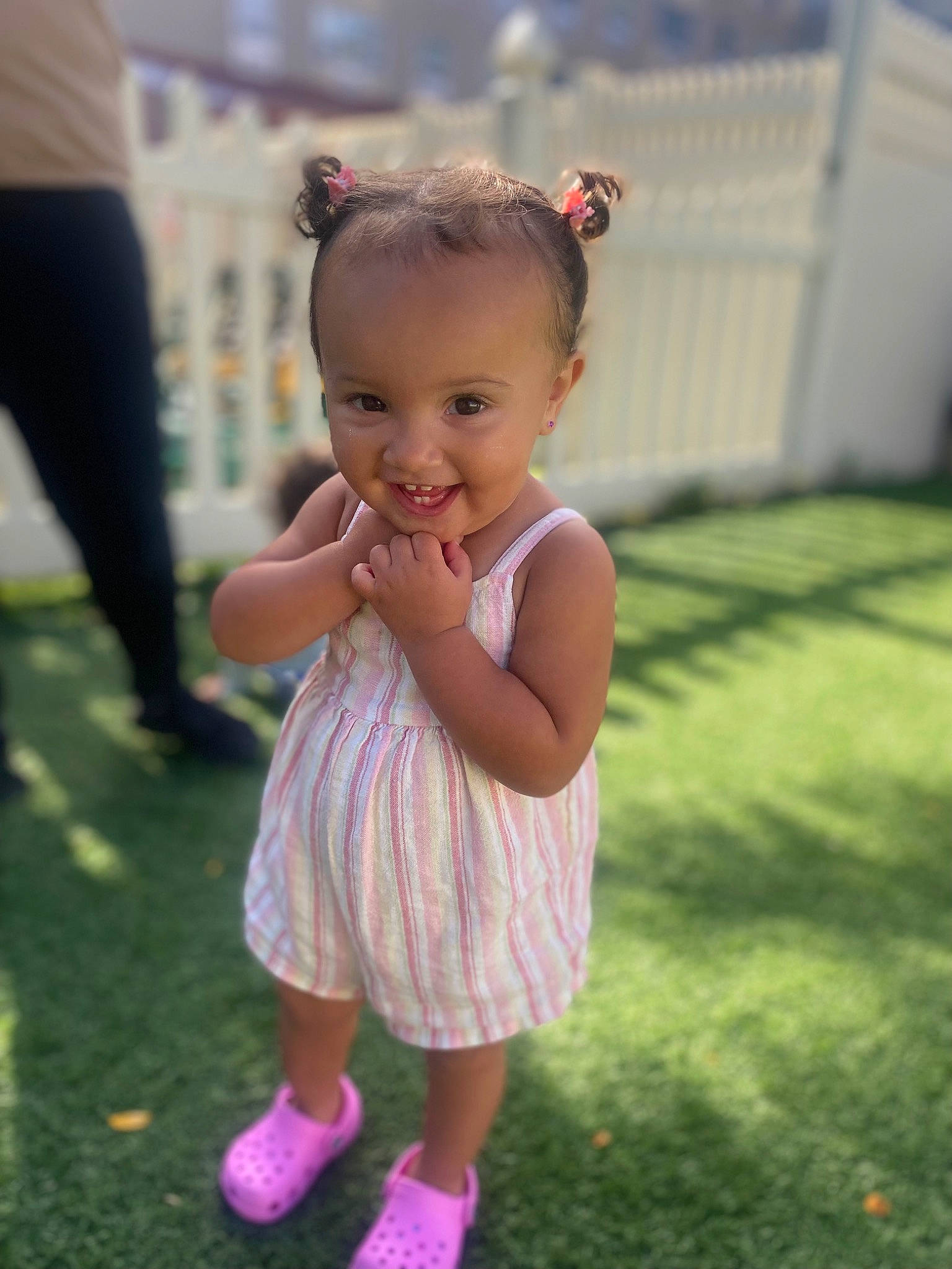 Mia is registered to the contest to win money with this photo: baby, baby_toddler_clothing, blond, child, dress, fun, gesture, grass, happy, iris, joy, leisure, lip, magenta, people_in_nature, person, pink, plant, recreation, skin