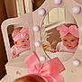 baby, pink_bow, headband, mirror, reflection, vanity, lights, cute, smile, infant, child, indoor, furniture, decor, window, curiosity, portrait, adorable, pink_clothing, hands