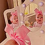 baby, pink_bow, mirror, reflection, vanity, lights, headband, smile, cute, infant, face, child, indoor, decor, furniture, table, window, curtains, flowers, happy
