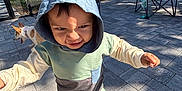 Arlo joined the competition — help win amazing prizes! toddler, child, hoodie, outdoor, patio, dog, chair, sunlight, pavement, expression, person, clothing, shadow, trees, nature, fence, grass, playful, casual, daylight