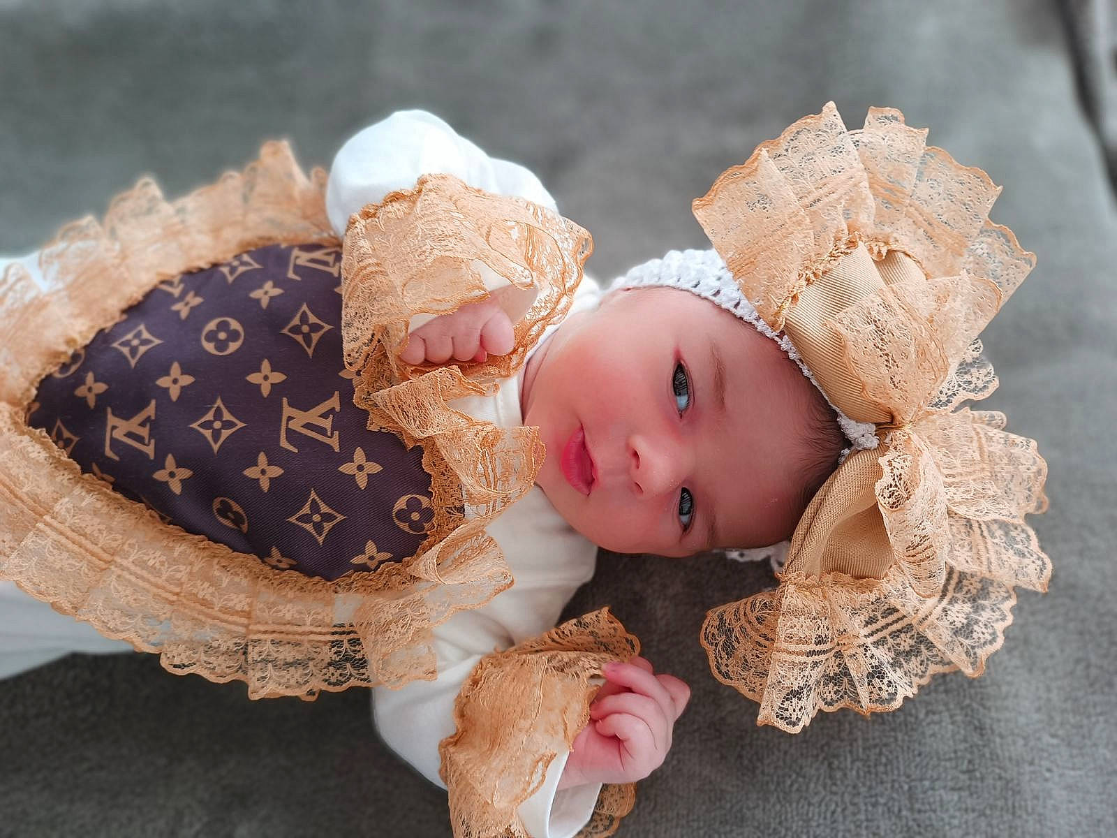 Mackenzie participe au concours pour gagner de l'argent avec cette photo : baby, baby_toddler_clothing, bridal_accessory, cap, costume_hat, doll, dress, embellishment, eye, eyelash, fawn, hand, head, headgear, headpiece, headwear, human_body, jewellery, person, pink