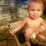 toddler, child, sand, stick, outdoor, barefoot, curious, squatting, nature, daylight, play, wooden_wall, skin, young_child, expression, person, summer, sunlight, ground, digging
