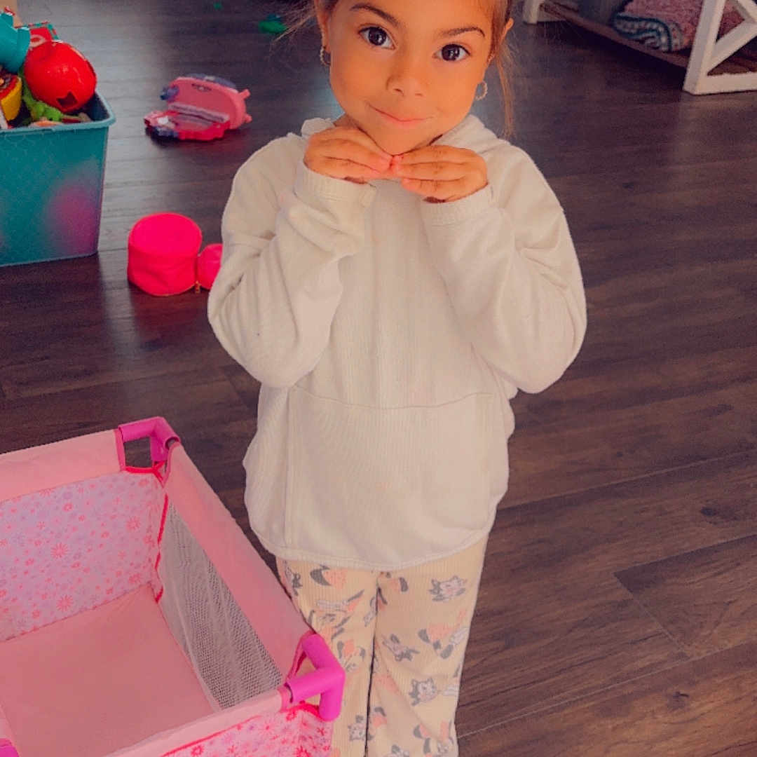 Stella is registered to the contest to win money with this photo: accessories, architecture, bag, building, child, couch, face, female, furniture, girl, handbag, hardwood, head, indoors, livingroom, person, photography, portrait, room, wood