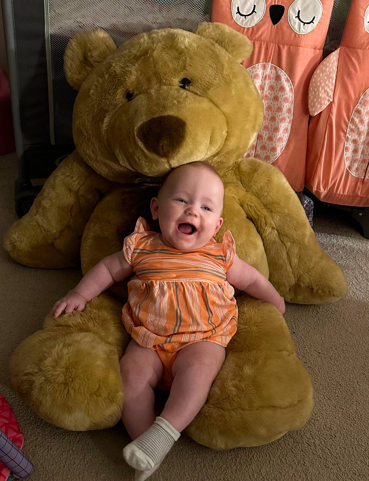 Skylar is registered to the contest to win money with this photo: baby, baby_toddler_clothing, cheek, child, comfort, eye, face, flooring, fur, happy, head, linens, person, pink, room, sitting, skin, smile, teddy_bear, toddler