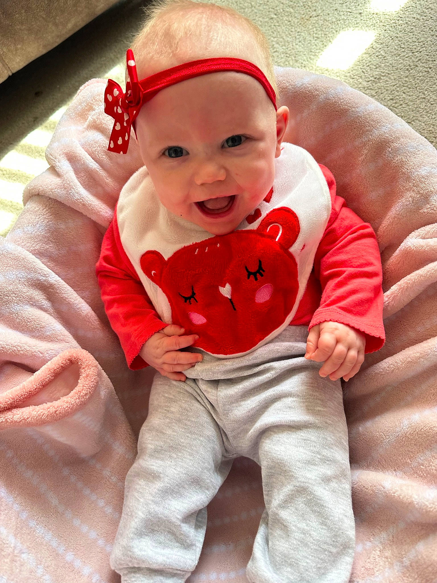 Skylar is registered to the contest to win money with this photo: baby, baby_toddler_clothing, carmine, child, comfort, costume_hat, face, fictional_character, fur, happy, headwear, holiday, linens, outerwear, pattern, person, pink, sitting, sleeve, smile