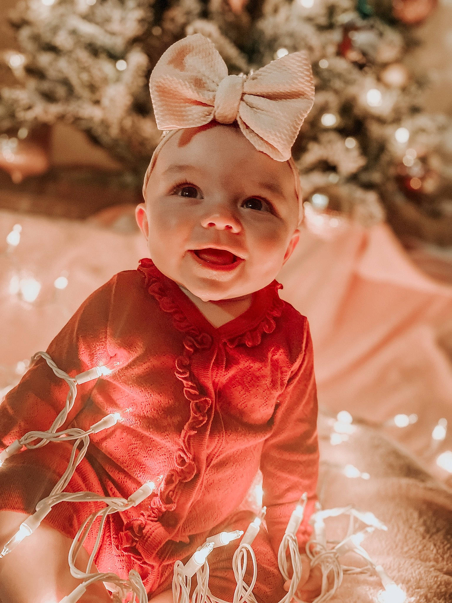 Emerie is registered to the contest to win money with this photo: baby, baby_toddler_clothing, christmas, christmas_decoration, christmas_ornament, dress, event, fawn, grass, happy, head, headgear, headwear, holiday, human_body, ornament, people_in_nature, person, pink, sleeve