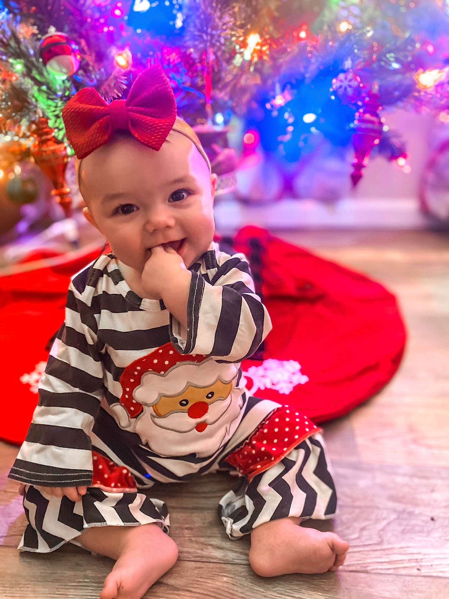 Emerie is registered to the contest to win money with this photo: baby, baby_toddler_clothing, blue, child, christmas_ornament, fawn, flooring, fun, happy, leisure, mammal, person, photograph, pink, plant, purple, red, smile, toddler, tree