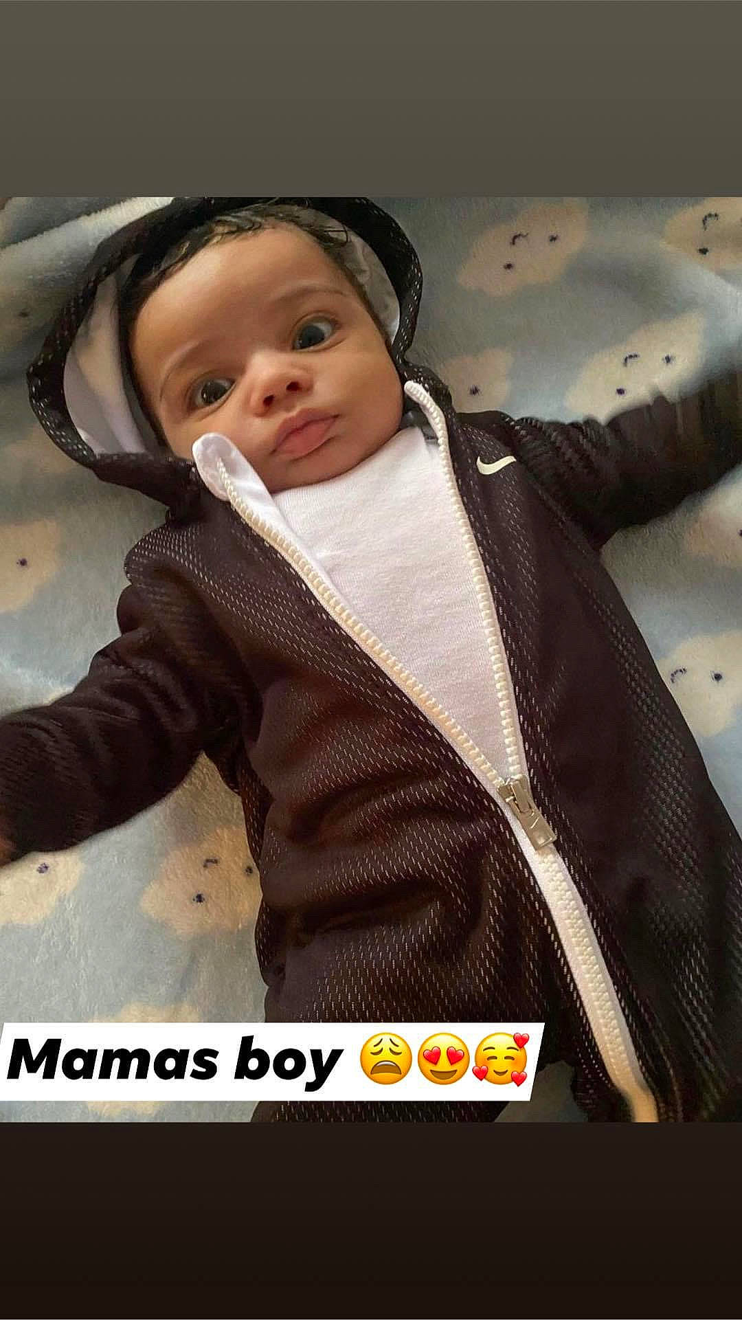 King is registered to the contest to win money with this photo: baby, baby_carriage, baby_products, baby_toddler_clothing, bib, child, fashion_accessory, font, formal_wear, fur, hood, hoodie, jacket, outerwear, pattern, person, personal_protective_equipment, sitting, sleeve, toddler