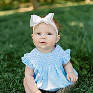 Vivienne is registered to the contest to win money with this photo: baby, child, girl, grass, outdoor, blue_dress, headband, bow, greenery, nature, sitting, portrait, cute, infant, summer, sunlight, happy, face, expression, young