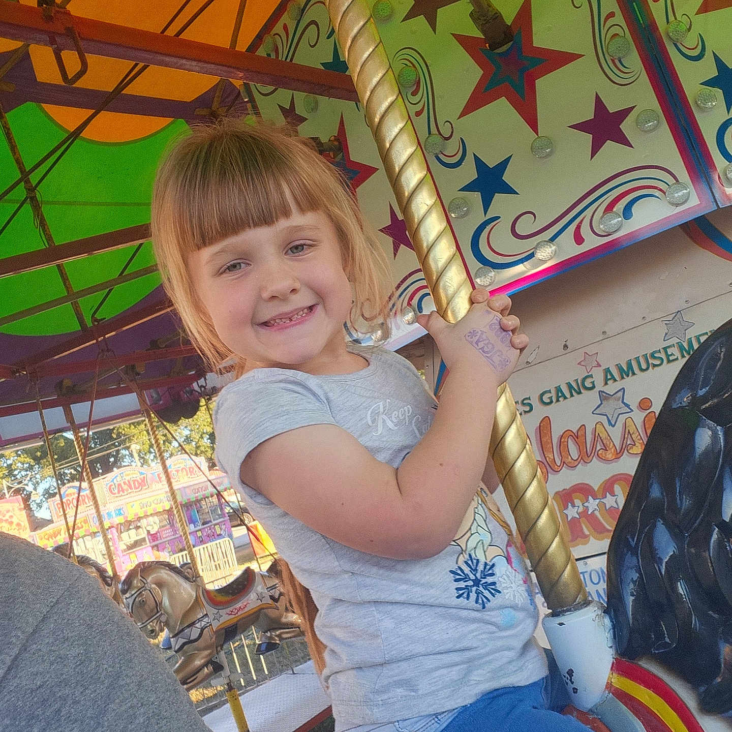 Kaylee joined the competition — help win amazing prizes! adult, amusementpark, animal, carousel, child, clothing, face, female, girl, head, horse, jeans, male, man, pants, person, photography, play, portrait, t_shirt