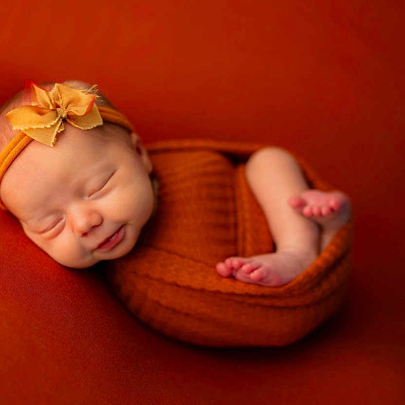Lorelai joined the competition — help win amazing prizes! baby, blanket, face, happy, head, newborn, person, photography, portrait, sleeping, smile