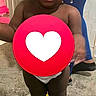 Adrianna is registered to the contest to win money with this photo: toddler, child, baby, standing, portrait, indoors, beaded_hair, braids, curious, smiling, face, person, toy, hoverboard, wheel, heart, clothing, diaper, doorway, floor