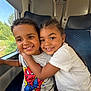 child, children, smiling, hug, train, window, seat, clothing, tshirt, braids, short_hair, happy, portrait, travel, indoor, boy, girl, friendship, cute, people