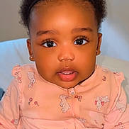 Keyliah Elora participe au concours pour gagner de l'argent avec cette photo : toddler, baby, child, face, eyes, pink_clothing, onesie, bunny_pattern, indoor, portrait, curly_hair, headband, sitting, hand, expression, cute, young, person, skin, earrings