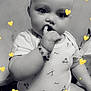baby, infant, child, cute, monochrome, black_and_white, sitting, onesie, bracelet, hand, finger_in_mouth, face, expression, indoors, heart_stickers, adorable, portrait, young, chubby, curious