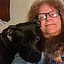 affection, casual, closeup, comfort, companion, couch, dog, friendly, glasses, hair, happy, indoor, pet, pillow, portrait, relaxed, resting, smile, tshirt, woman