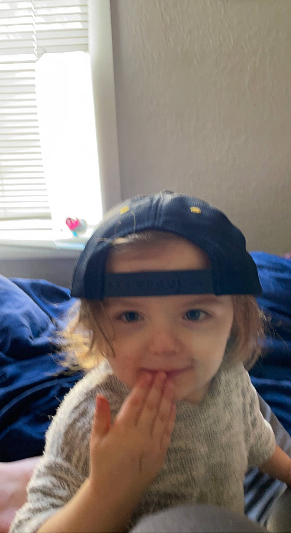 Nova is registered to the contest to win money with this photo: brown_hair, cap, child, eyebrow, eyelash, face, fun, fur, hairstyle, happy, head, headgear, headwear, iris, lip, long_hair, nose, person, sitting, toddler