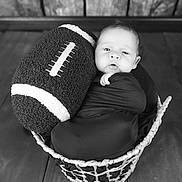 Mason is registered to the contest to win money with this photo: baby, infant, newborn, basket, football, prop, swaddle, portrait, black_and_white, wood_floor, wood_paneling, cute, cozy, sleeping, face, eyes, indoor, soft_texture, photography, blanket