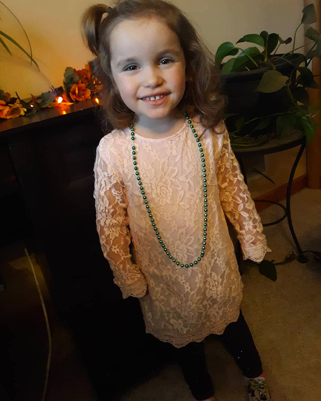 Madalynn is registered to the contest to win money with this photo: baby_toddler_clothing, cheek, dress, embellishment, event, eye, fashion_design, flash_photography, flooring, hair, happy, head, houseplant, human_body, iris, joy, person, plant, skin, sleeve