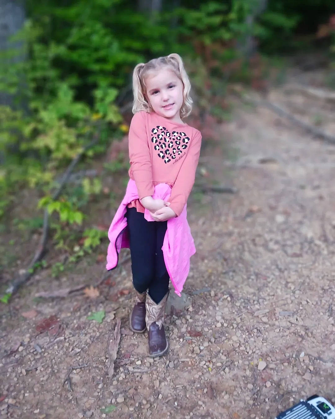 Alana is registered to the contest to win money with this photo: child, face, fawn, footwear, forest, grass, happy, joy, landscape, leisure, magenta, people_in_nature, person, pink, plant, recreation, shoe, smile, toddler, tree