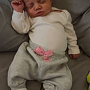 Aoife is registered to the contest to win money with this photo: baby, bed, blanket, child, clothing, cozy, cute, gray_pants, indoors, infant, newborn, peaceful, pink_bow, portrait, relaxed, resting, sleeping, socks, soft, white_shirt