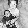 Liam a rejoint le concours — aidez-le/la à gagner de superbes lots ! baby, toddler, child, smile, sleeping, onesie, blanket, indoor, portrait, family, sibling, holding, cute, black_and_white, hair, face, comfort, cozy, infant, cuddling