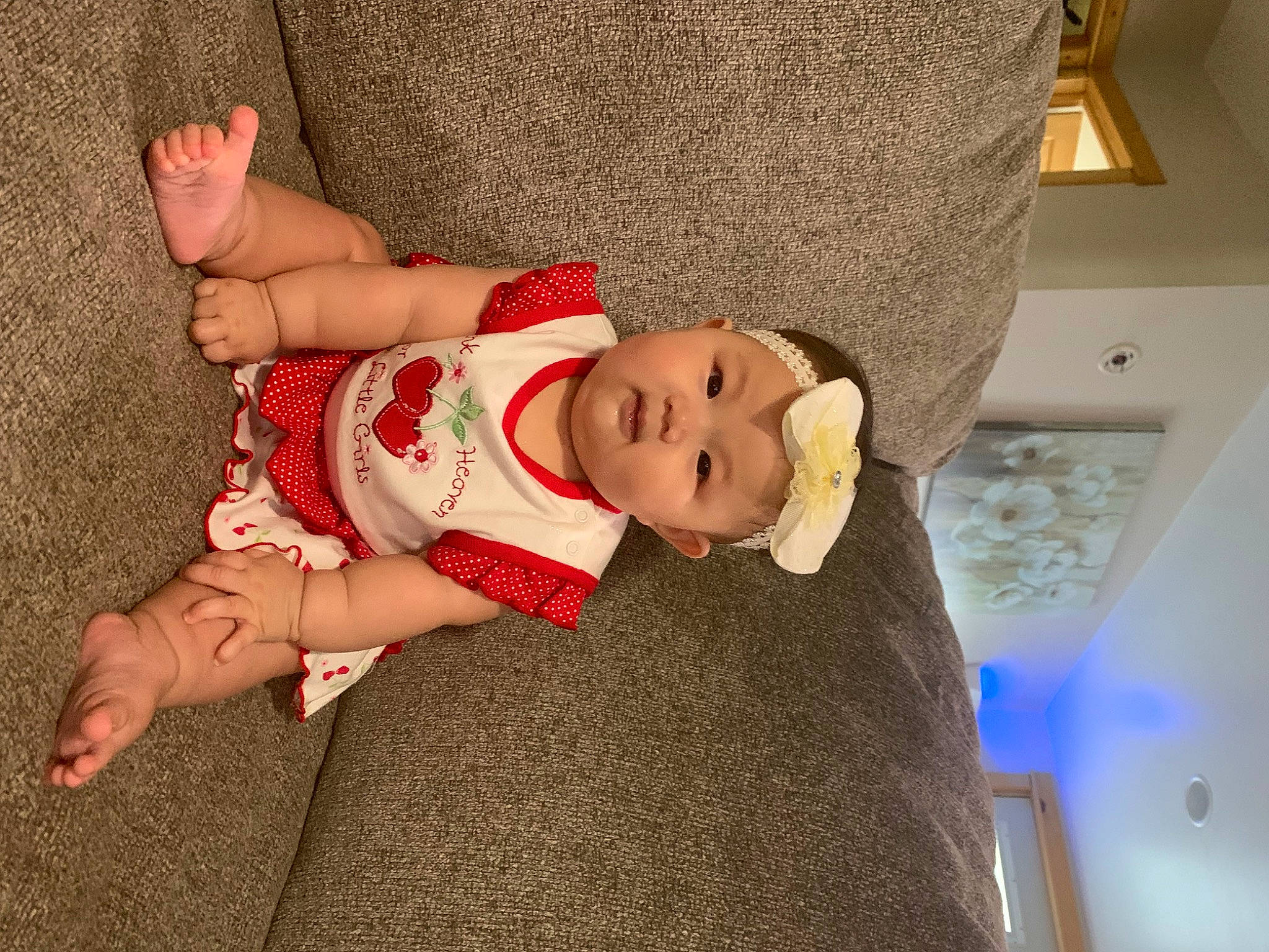 Emryss Yang is registered to the contest to win money with this photo: abdomen, baby, baby_toddler_clothing, child, comfort, fawn, flooring, foot, fun, hat, headwear, human_leg, knee, lap, person, sitting, sock, thigh, toddler, trunk