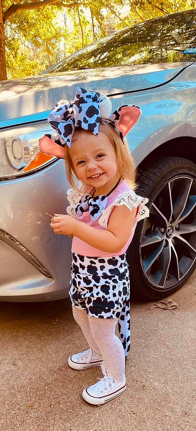 Brenley is registered to the contest to win money with this photo: alloy_wheel, automotive_design, automotive_exterior, automotive_lighting, automotive_tire, blue, bumper, car, fashion, happy, headwear, hood, joy, motor_vehicle, person, photograph, shoe, smile, street_fashion, tire