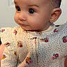 Luna is registered to the contest to win money with this photo: baby, child, infant, onesie, clothing, pattern, floral, cute, portrait, indoors, face, head, skin, person, sitting, expression, young, small, cozy, soft_light