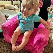 Oaklee is registered to the contest to win money with this photo: baby, child, infant, onesie, pink_chair, plush_chair, minnie_mouse, toy, carpet, indoor, furniture, person, cute, curious, home, colorful, soft, seated, playroom, expression