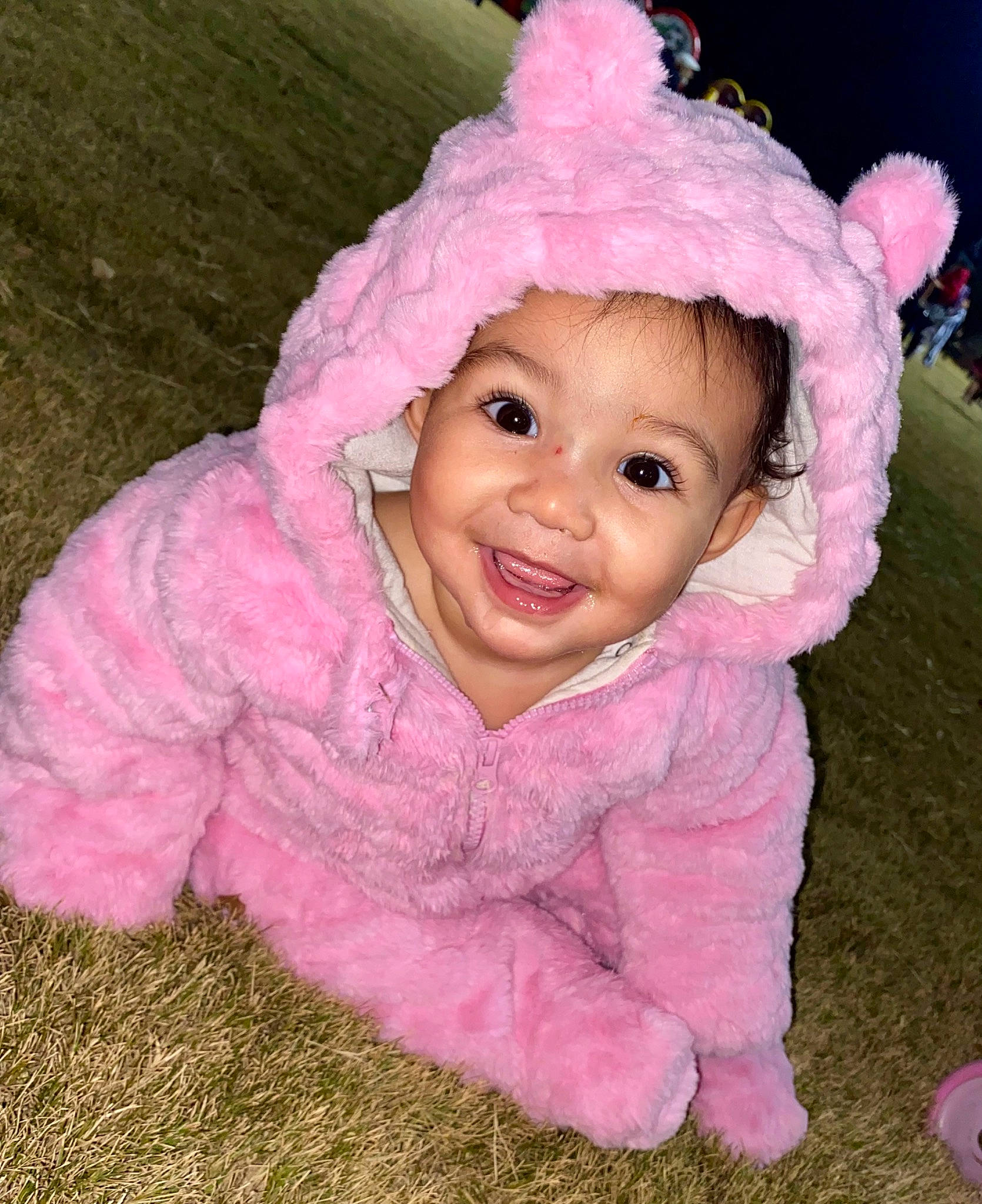 Ameliana is registered to the contest to win money with this photo: baby, baby_toddler_clothing, beanie, cap, cheek, child, costume_hat, fashion_accessory, fun, grass, happy, headwear, iris, joy, knit_cap, magenta, nose, person, pink, sleeve