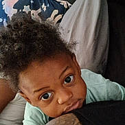 Waylon joined the competition — help win amazing prizes! toddler, child, person, arm, tattoo, hand, face, curly_hair, bed, pillow, blanket, indoor, closeup, expression, lock_screen, phone_interface, time_display, date_display, skin, clothing