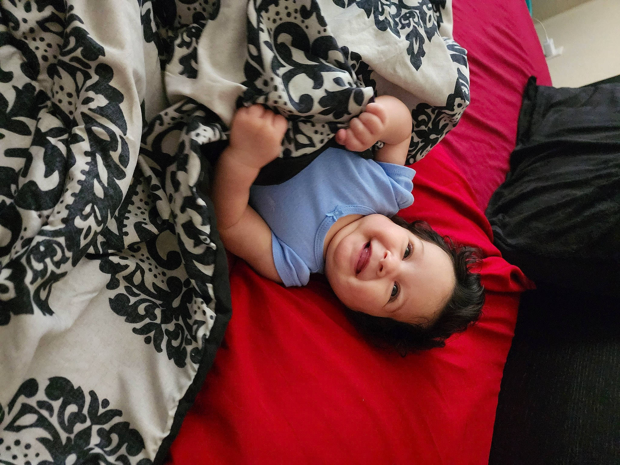 Natasha is registered to the contest to win money with this photo: black_hair, comfort, cool, elbow, fashion, fun, gesture, grass, happy, human_leg, joint, joy, linens, person, plant, sitting, sleeve, smile, t_shirt, textile