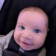 Juan is registered to the contest to win money with this photo: baby, infant, child, smiling, portrait, close_up, face, eyes, happy, car_seat, safety_harness, seatbelt, blanket, clothing, indoor, vehicle, photography, head, mouth, baby_carrier