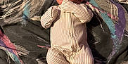 Elias is registered to the contest to win money with this photo: baby, blanket, child, colorful, comfort, curious, cute, expression, fabric, face, indoor, infant, laying_down, newborn, onesie, pattern, person, portrait, sleepwear, soft