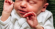 Lyra is registered to the contest to win money with this photo: baby, blanket, child, closeup, cozy, cute, face, hand, human, indoors, infant, newborn, peaceful, portrait, resting, sleeping, smiling, soft_lighting, toddler, white_clothing