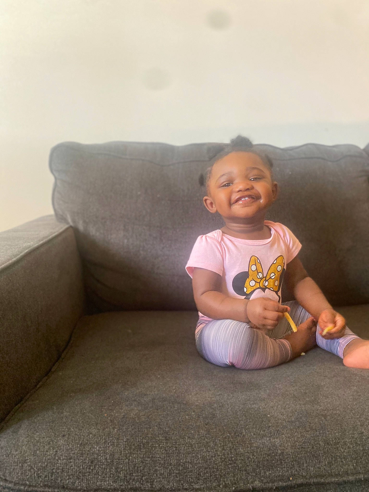A'Mylah is registered to the contest to win money with this photo: baby, baby_toddler_clothing, comfort, couch, eye, face, flash_photography, flooring, hair, hand, happy, head, human_body, joy, person, sitting, skin, sleeve, smile, t_shirt