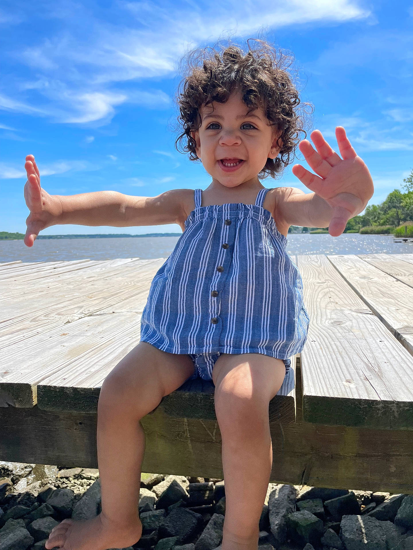 Jaelynn joined the competition — help win amazing prizes! bodypart, child, clothing, face, female, finger, girl, hair, hand, head, person, photography, pier, portrait, rock, shorts, sitting, water, waterfront, wood